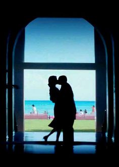 a movie poster with a couple kissing in front of an open window and the words punch drunk love