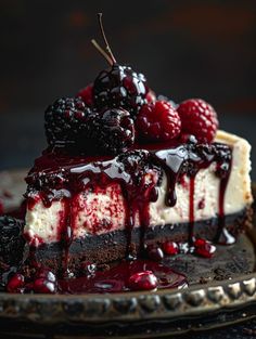 a slice of cheesecake with berries on top and chocolate sauce drizzled over it