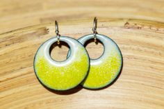 These retro bright yellow-green dangle earrings are perfect to add a pop of neon color to your look. Theyre 3/4 inch across, and a great shade of chartreuse acid green layered over a cream-colored base. They transition from a creamy off-white at the top to the acid green at the bottom, with a Neon Yellow Drop Earrings As A Gift, Yellow Enamel Earrings, Green Dangle Earrings Cadmium-free, Green Cadmium-free Dangle Earrings, Green Chartreuse, Retro Earrings, Chartreuse Green, Retro Earring, Green Jewelry