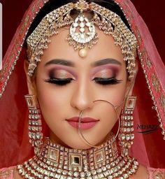 a woman with makeup and jewelry on her face