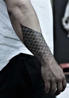 a man with a black and white tattoo on his arm