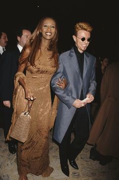 a man and woman walking together at an event