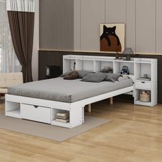 a white bed sitting on top of a wooden floor