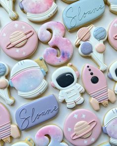 the cookies are decorated in different colors and designs, including astronaut's name on them