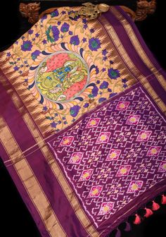 This silk saree showcases stunning Radha Krishna designs, expertly created using the highly desirable Kalamkari technique and incorporating traditional Pichwai elements. The intricate hand-painted motifs in soothing shades of sandle and purple stand out against a backdrop of delicate floral vines. The Ikkat pallu and Stack border add an element of refinement to this magnificent piece, making it a truly exceptional creation. SILK MARK CERTIFIED This saree is ready to wear with fall and pico done. Handmade silk tassels adorn the pallu and add more grace to it. An unstitched blouse fabric is included. *Note: There may be minor variations in the shade, the texture of the product. Hues/textures show differently due to variations in screen settings and other factors, *Note: This is a handwoven s Multicolor Ikat Print Pre-draped Saree For Navratri, Fusion Style Multicolor Dupatta With Zari Work, Multicolor Fusion Dupatta In Traditional Drape, Multicolor Fusion Dupatta With Traditional Drape, Fusion Style Multicolor Dupatta In Traditional Drape, Fusion Style Multicolor Traditional Dupatta, Fusion Style Semi-stitched Dupatta For Navratri, Fusion Style Traditional Drape Dupatta For Navratri, Fusion Multicolor Traditional Wear With Zari Work