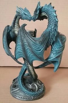 a blue dragon statue sitting on top of a table