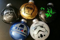 five star wars ornaments are sitting on a table