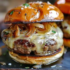 a cheeseburger with onions and meat on it