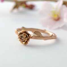 a rose ring sitting on top of a white table