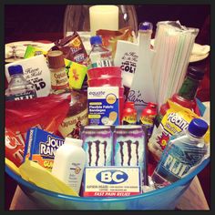 a blue bowl filled with lots of different types of drinks and condiments on top of a table