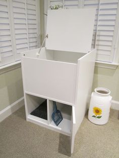 a white cabinet with drawers in the corner