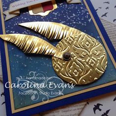 a close up of a card with a gold leaf on the front and blue back