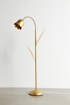 a lamp that is sitting on top of a table in front of a white wall