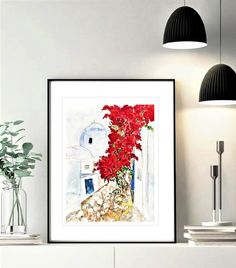 a painting is hanging on the wall next to a vase with red flowers in it