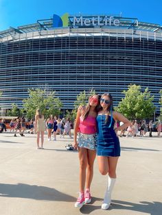 two young women standing in front of a building with the words metlife on it