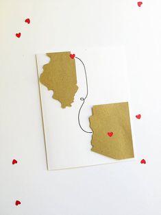 two pieces of paper cut out to look like the state of indiana with hearts on them