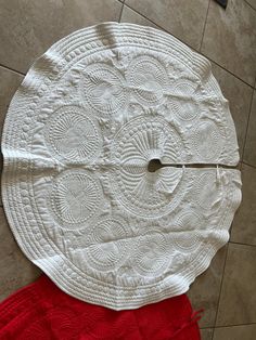 a white table top sitting on top of a tile floor next to a red rug