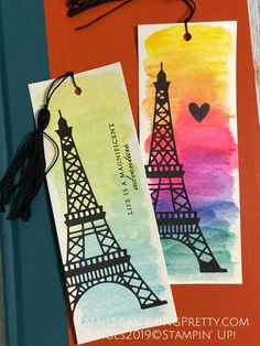 two tags with the eiffel tower painted on them