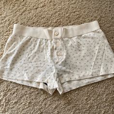 Eyelet Cotton Undies In A Boy Short Cut With A Thick, Elastic Waistband, And Button Detail, In A Floral Print All Intimates Are Final Sale. Fabrics: 96% Cotton, 4% Elastane Measurement: 8.5" (22 Cm) Rise, 27" (69 Cm) Waist (Stretches) Made In: Europe Brandy Boxer Short, Brandy Melville Sleep Shorts, Brandy Melville Pjs Shorts, Brandy Melville Boxer Shorts, Boyshorts Outfit Women, Brandy Melville Undies, Cotten Shorts, Brandy Melville Pjs, Cute Pj Shorts