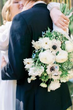 the bride and groom are hugging each other