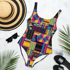 Royal Kente Print One-Piece Swimsuit, African Print bathing suit, Ankara Swimwear, Vibrant Colored Beachwear This one-piece swimsuit for all figures will bring out your best features. Enjoy the smooth fabric and the flattering design, and show it off by the sea or pool! * 82% Polyester, 18% Spandex * Fabric weight: 6.61 oz/yd² (224 g/m²) * Chlorine-resistant fabric * Cheeky fit with a scoop neckline and a low scoop back * Zig-zag stitching * Double-layer front  * Four-way stretch material stretc Fitted Multicolor One-piece For Sunbathing, Fitted Bold Print Swimwear For Vacation, Fitted Swimwear With Bold Print For Sunbathing, Multicolor Sleeveless Bodysuit For Beach Season, Fitted Tropical One-piece Swimsuit For Sunbathing, Fitted Tropical One-piece For Sunbathing, Tropical Fitted One Piece For Sunbathing, Bold Print Swimwear For Vacation Beachwear, Bold Print Beachwear Swimwear For Vacation