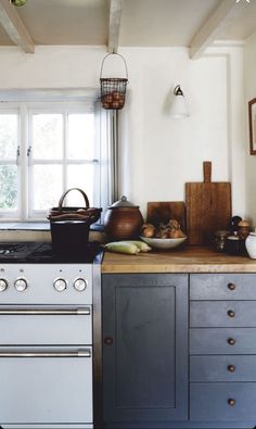 a kitchen with an oven, sink and window