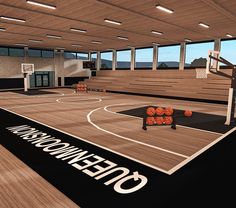 an indoor basketball court with orange balls on the floor and in the middle of it