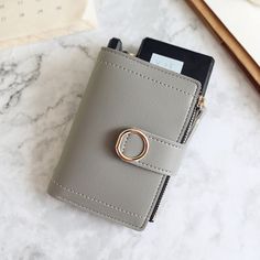 Main Material: PUOrigin: CN(Origin)Wallet Length: ShortLining Material: Synthetic LeatherPattern Type: SolidStyle: FashionInterior: Coin PocketInterior: Photo HolderInterior: Card HolderGender: WOMENClosure Type: HaspWallets: Standard WalletsDecoration: ButtonItem Weight: 80gItem Height: 9cmItem Width: 3.5cmItem Length: 12.5cm Simple Wallet, Small Leather Purse, Buckle Ring, Cute Wallets, Luxury Purses, Pu Leather Wallet, Clip Wallet, Wallet Pattern, Short Wallet