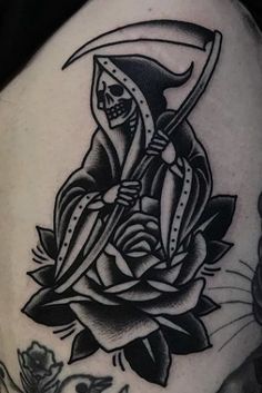 a black and white image of a rose with a skeleton on it's side