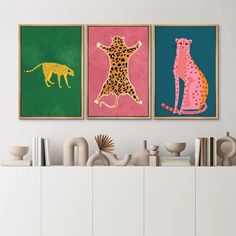 three framed art prints on a wall above a dresser