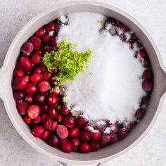 cranberries and other ingredients in a pot with sugar on the top, ready to be cooked