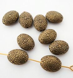 several brown beads sitting on top of a wooden stick