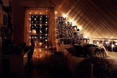 an attic bedroom decorated with lights and pictures