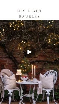 an outdoor table and chairs with lights on them