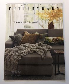 the cover of pottery barn magazine features a couch with pillows on it and a coffee table