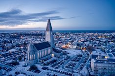 an aerial view of a large church in the middle of a city at night time