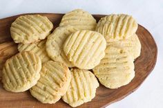 a wooden plate filled with cookies on top of a table