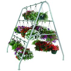 three tiered metal plant stand with hanging flower pots and flowers in the bottom row