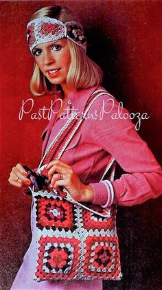 a woman is holding a crocheted purse