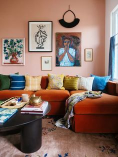 a living room filled with furniture and pictures on the wall above it's coffee table