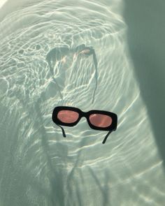 a pair of sunglasses floating in the water