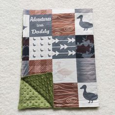 a quilted blanket with ducks and arrows on it, along with the words adventures with daddy