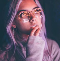 a woman wearing glasses with the word girl on her face in front of her eyes