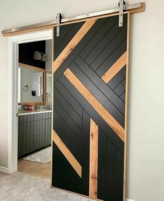 an open sliding door with wood strips on the bottom and sides, in a bathroom