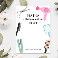 a card with scissors, hairdryer and other items on it next to cotton flowers