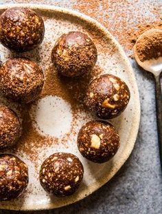 chocolate truffles on a plate with spoons next to it