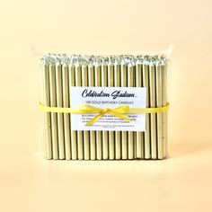 a pack of candles wrapped in yellow ribbon