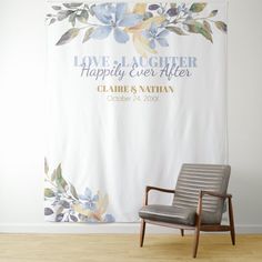 a chair sitting in front of a wall with a sign on it that says love laughter happily ever after