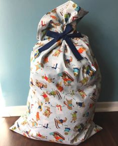 a large bag sitting on top of a hard wood floor next to a blue wall