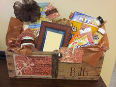 a wooden box filled with lots of different types of items on top of a table